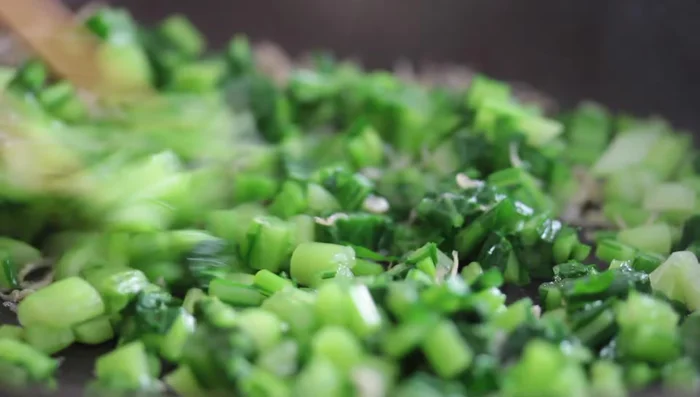 Add sesame seeds and continue stir-frying.