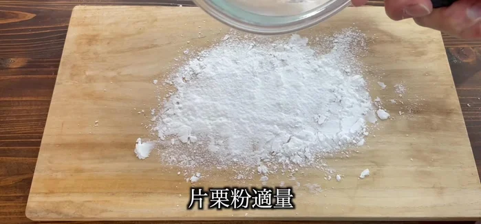 Dust a work surface with potato starch. Place the mochi dough on the starch and coat it thoroughly.