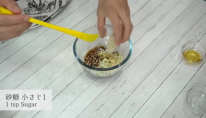 Combine chopped ingredients with soy sauce, vinegar, sugar, sesame oil, and white sesame seeds in a bowl. Mix well.