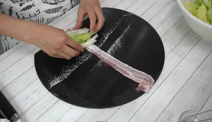 Wrap the pork belly around the cabbage, rolling tightly. Tuck the end underneath.