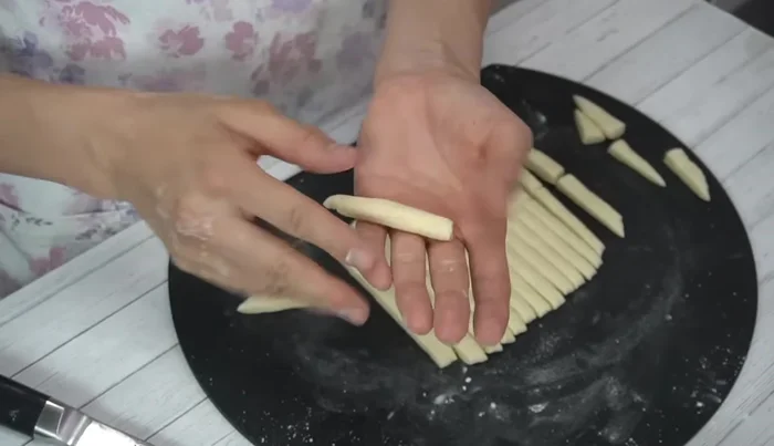 Roll each strip into a ball, gently shaping and removing sharp corners. Karinto are naturally irregular, so don't worry about perfect shapes.
