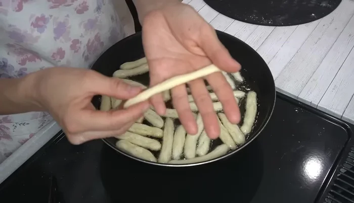 Flip karinto pieces as they start to brown. Fry for about 10 minutes, until golden brown and crispy. Remove from oil and let drain for 3 minutes.