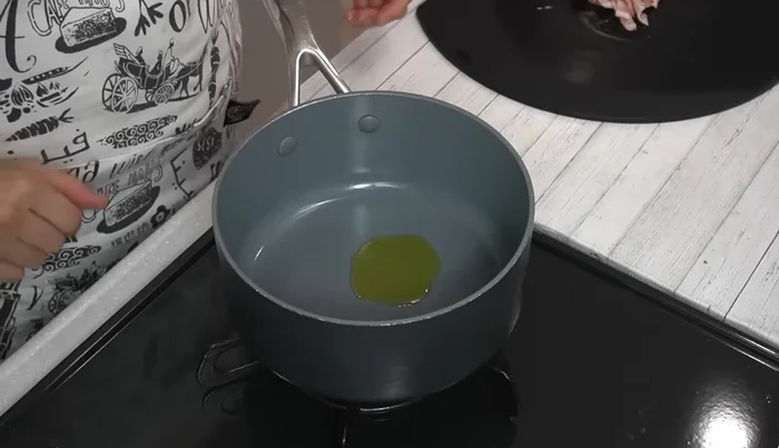 Heat olive oil in a pot over medium heat. Add bacon and fry until lightly browned.