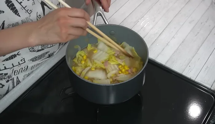 Add potato consomme and water. Mix well and bring to a boil over medium heat.