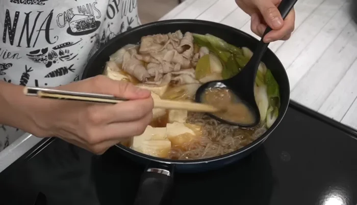 Add miso: Dissolve miso in some broth and pour over the ingredients. Simmer for 2 minutes.