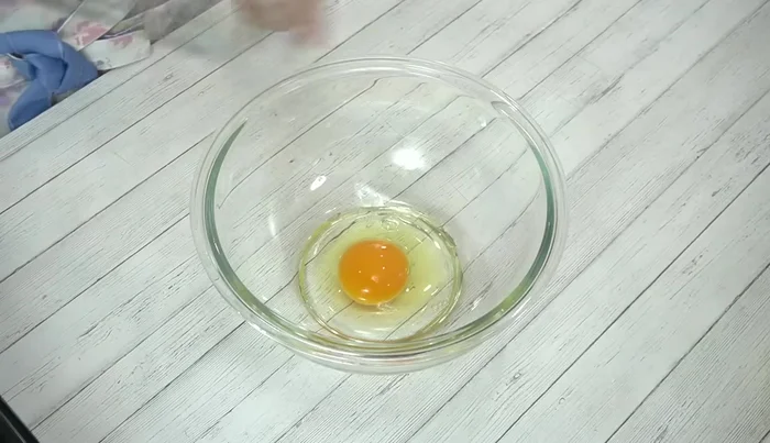 Crack eggs into a bowl and beat lightly with a whisk.