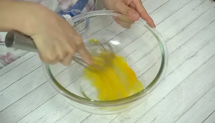 Crack an egg into a bowl, add mirin, and mix well. Add the melted butter and mix until well combined.