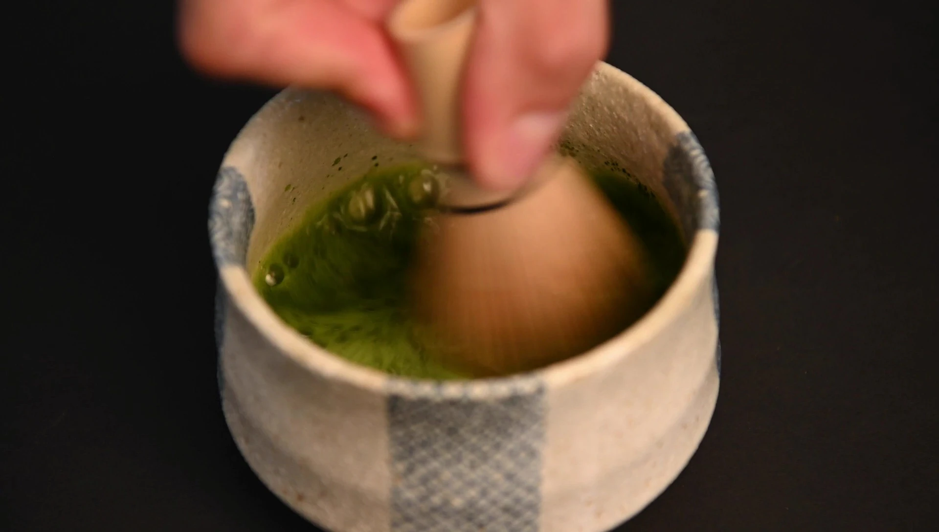 Bamboo whisk frothing matcha tea