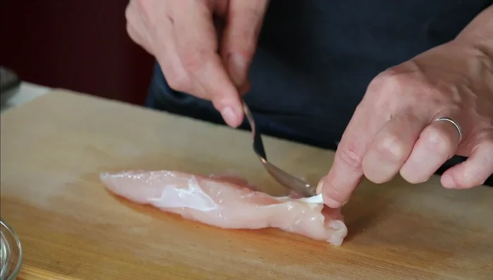 Remove tendons from chicken tenderloin. Cut each tenderloin into two pieces.