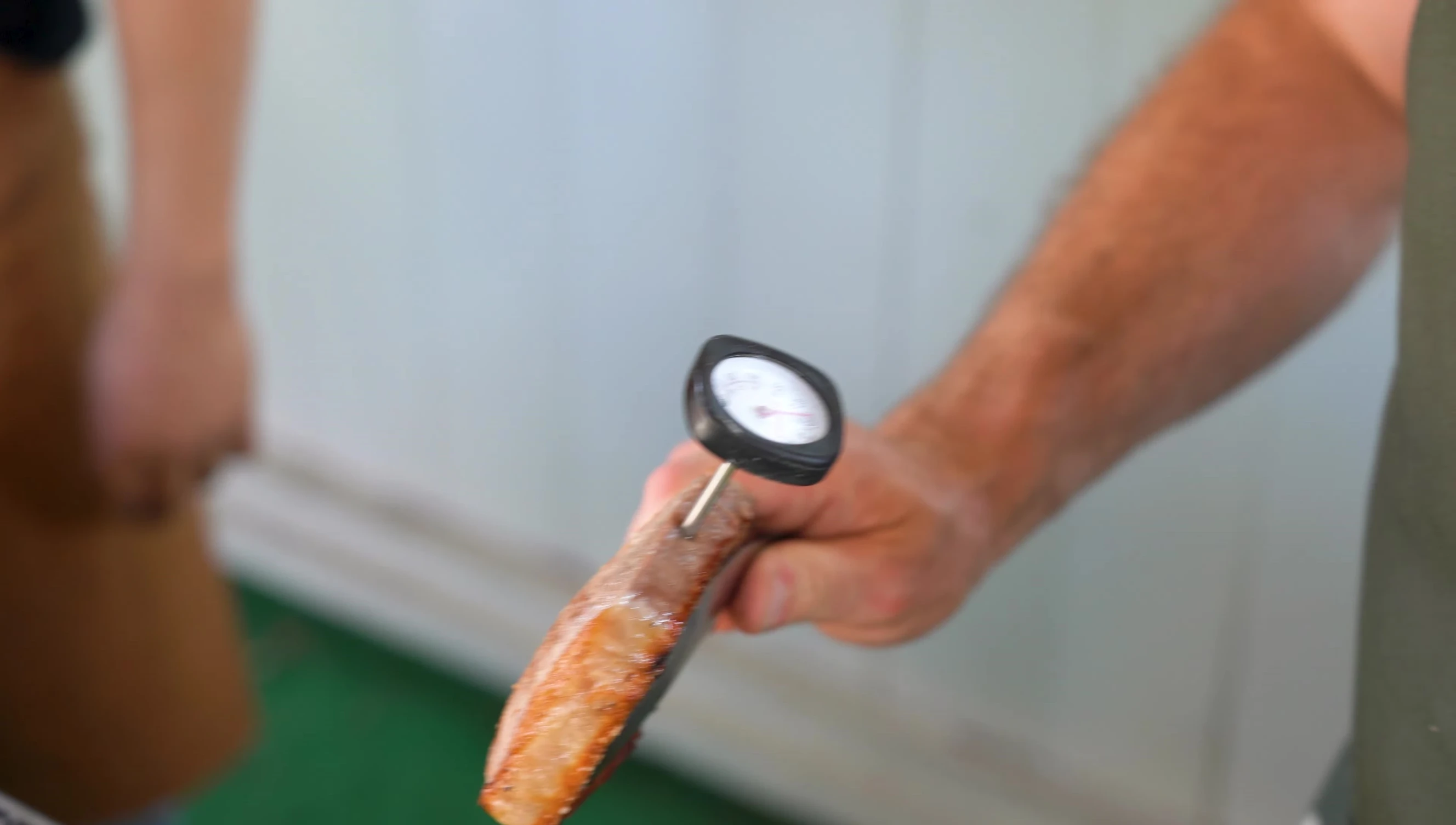 Checking steak doneness with meat thermometer