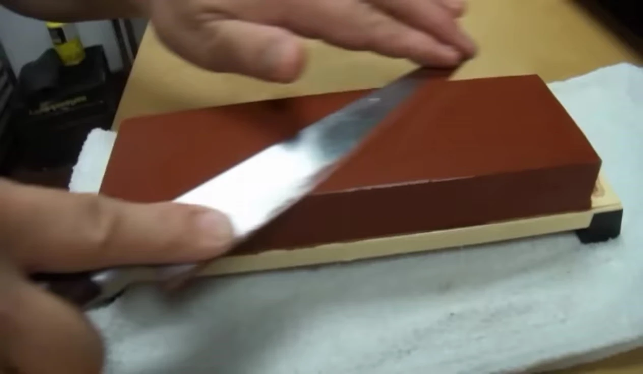 Sharpening knife on whetstone at 15°