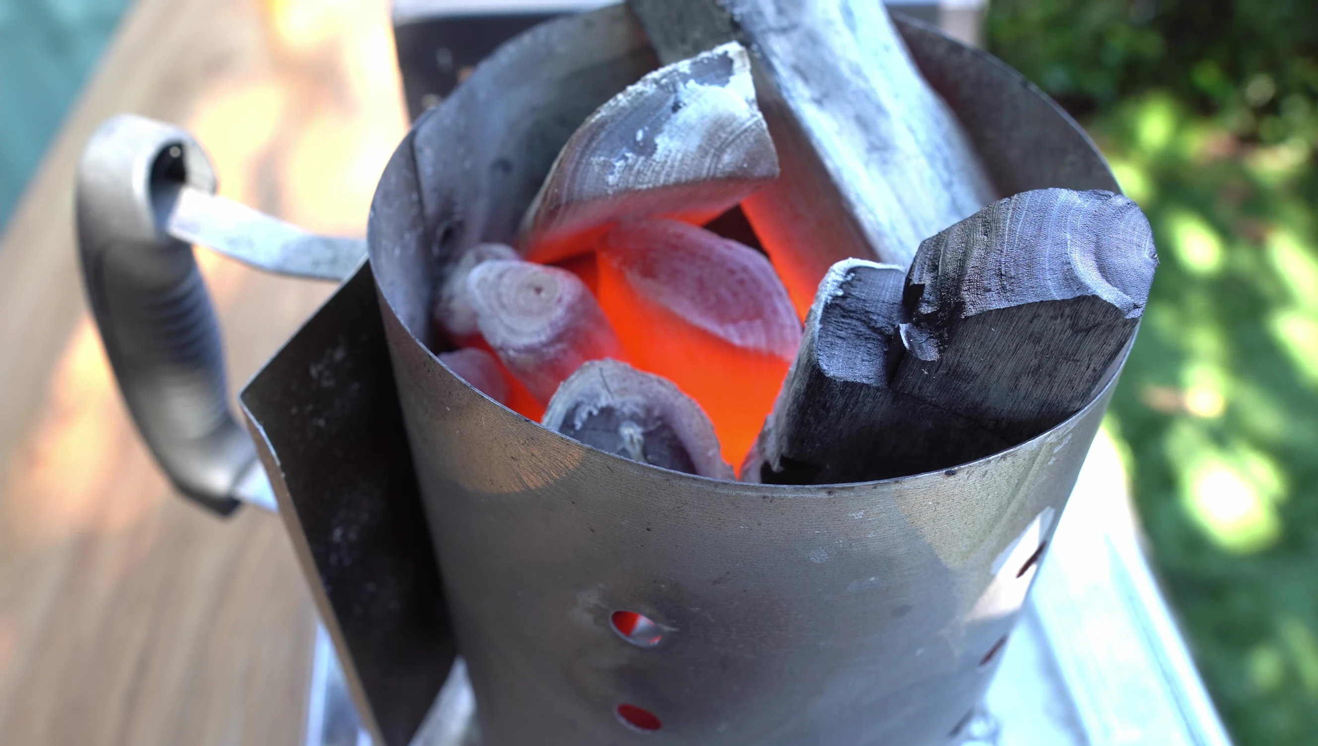 Glowing bincho-tan charcoal in a chimney starter.