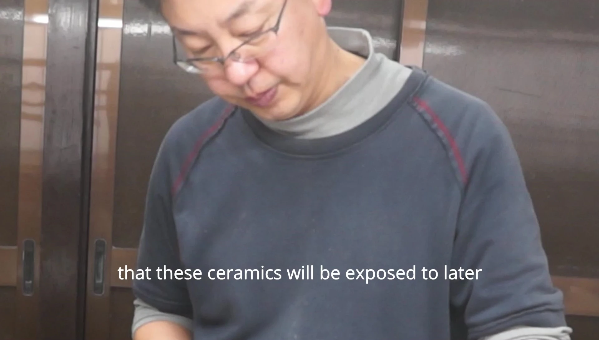 Artisan using a special blade for glaze application.