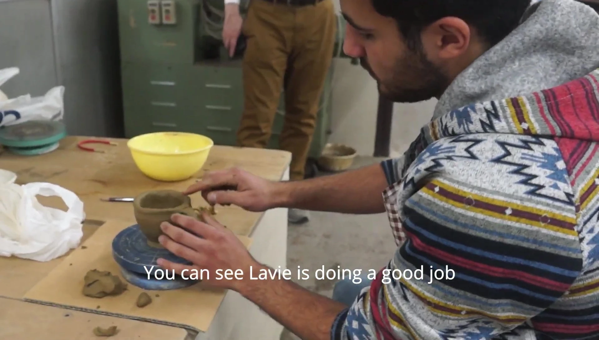 The narrator working on their pottery piece.