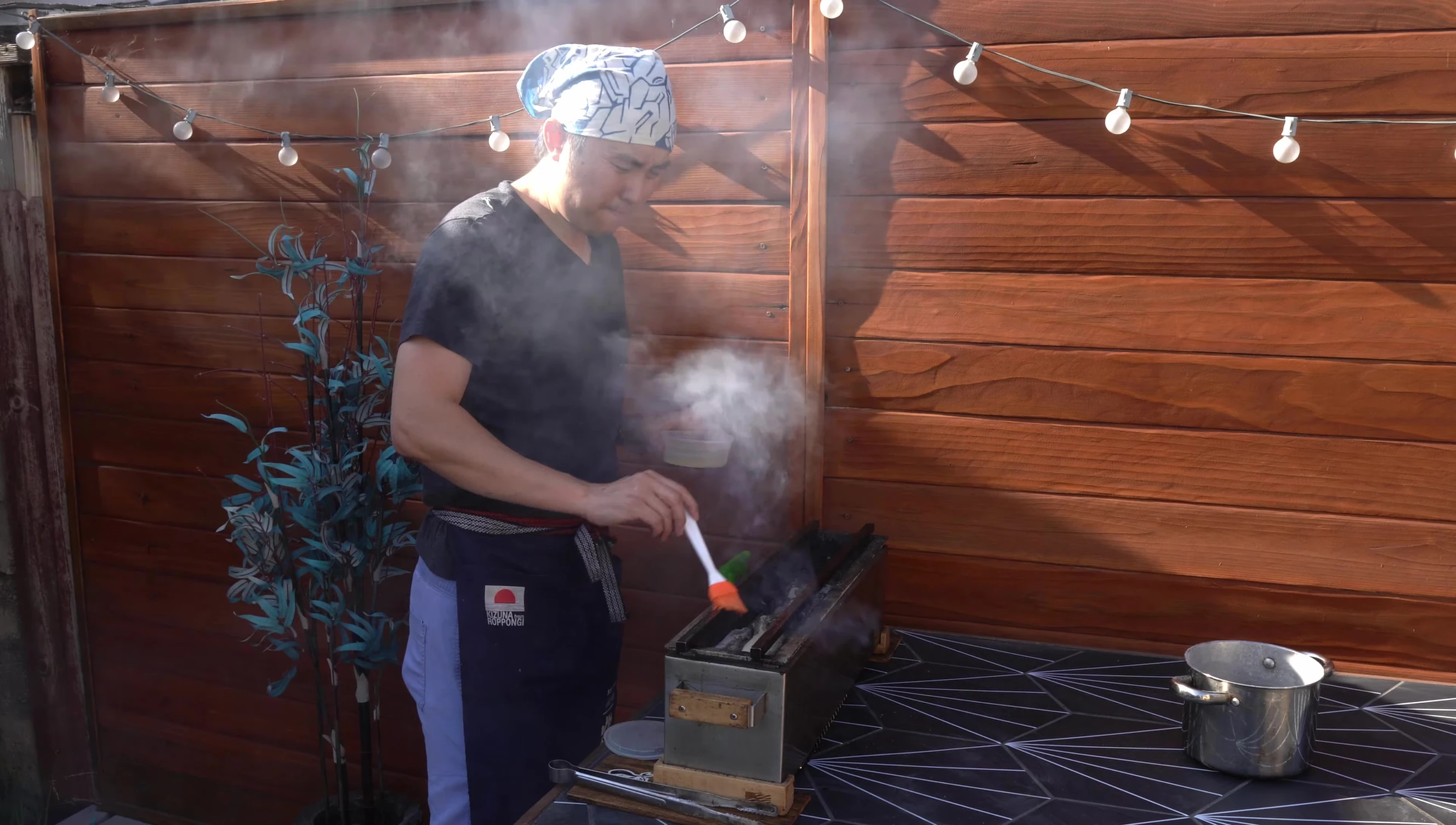 Chef grilling yakitori using Binchotan charcoal.