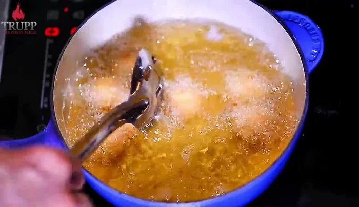 Deep fry the breaded eggs until golden brown, ensuring not to overcook.