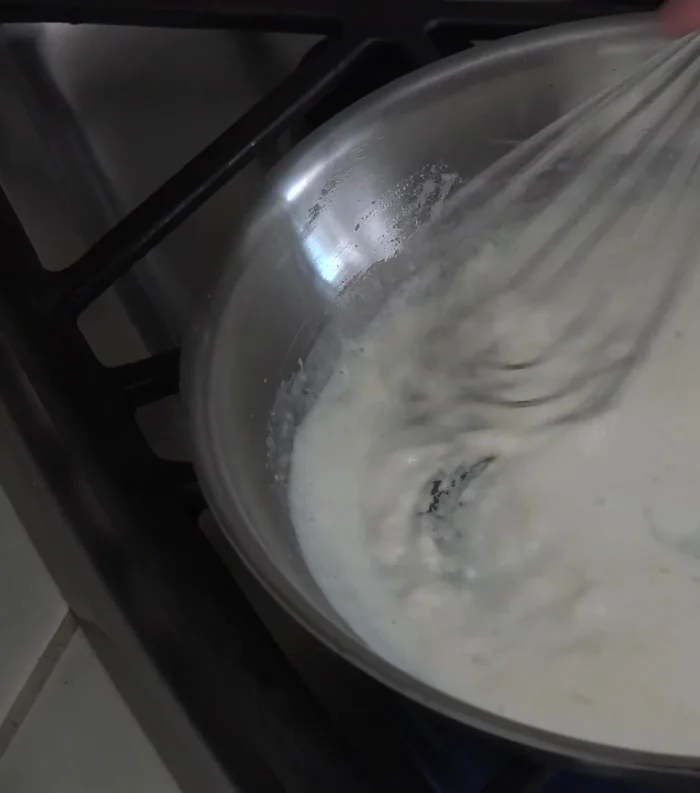 Pour half the milk, stir and whisk to blend. Add remaining milk and whisk until very smooth. The texture should be thicker than usual to hold shape.