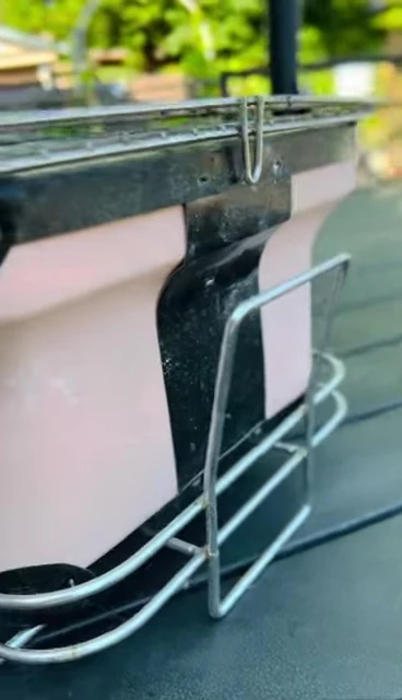 Shot showcasing the size and weight of the grill.