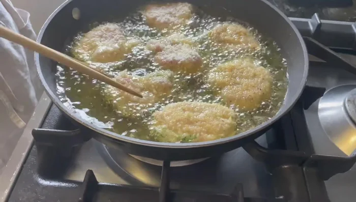 Deep-fry the hirekatsu for 2-3 minutes per side, flipping to ensure even golden-brown coloring.