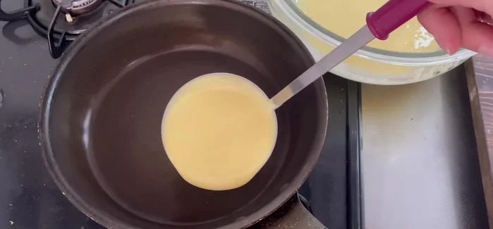 Cook over low heat until the surface is slightly dry and holes start to appear.
