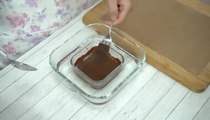 Coat each chocolate square with the melted coating chocolate using a fork. Tap the fork to remove excess chocolate.