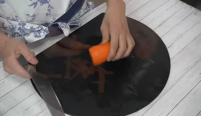 Peel and slice carrots into egg-shaped pieces.