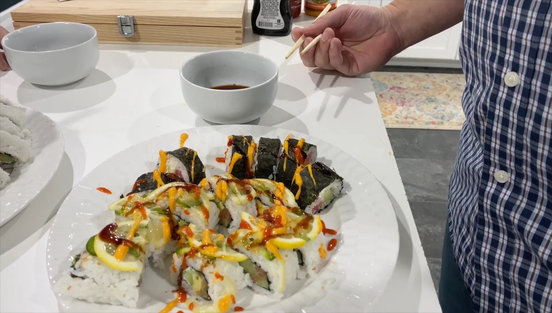 The chef and friend are tasting the finished sushi.