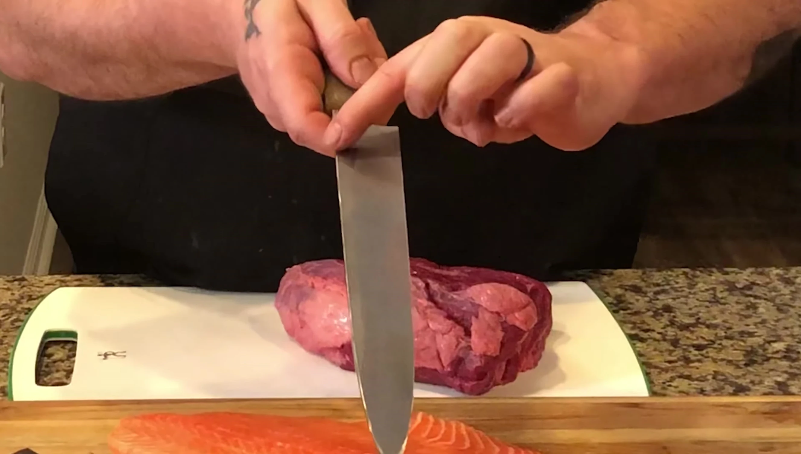Close-up of the Yanagiba knife, emphasizing its single bevel and the slightly shiny edge.