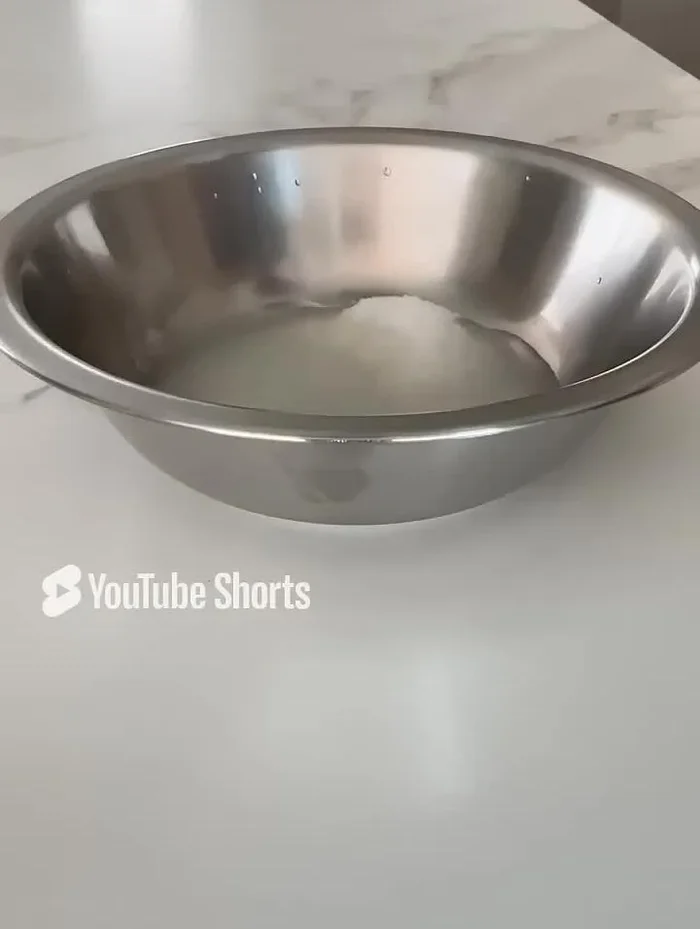 Prepare the rice seasoning by mixing sugar, salt, vinegar, and water (quantities in video description). Let it sit; the vinegar will dissolve the ingredients.
