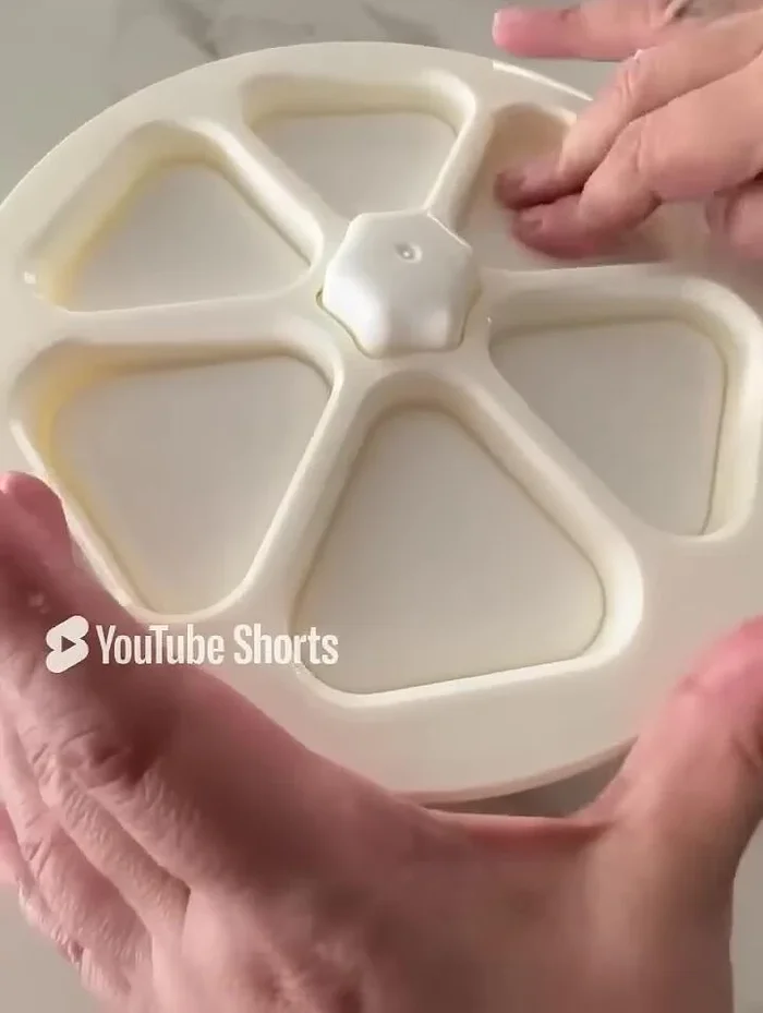 Press the mold to compact the rice. Invert the mold to release the onigiri.