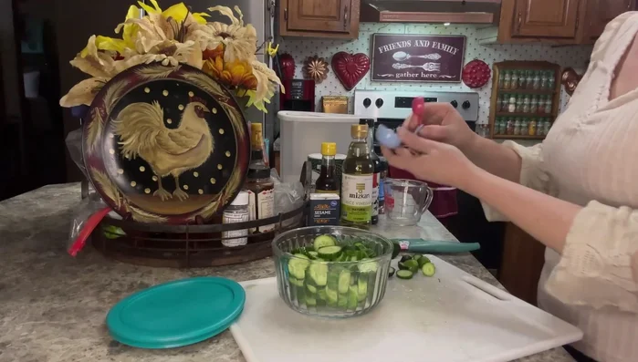 Place cucumbers in a bowl. Sprinkle with 1 tablespoon of salt and 1 tablespoon of sugar. Mix gently.