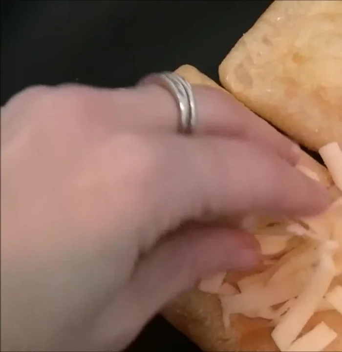 Spread shredded cheese on one side of one tofu pocket.