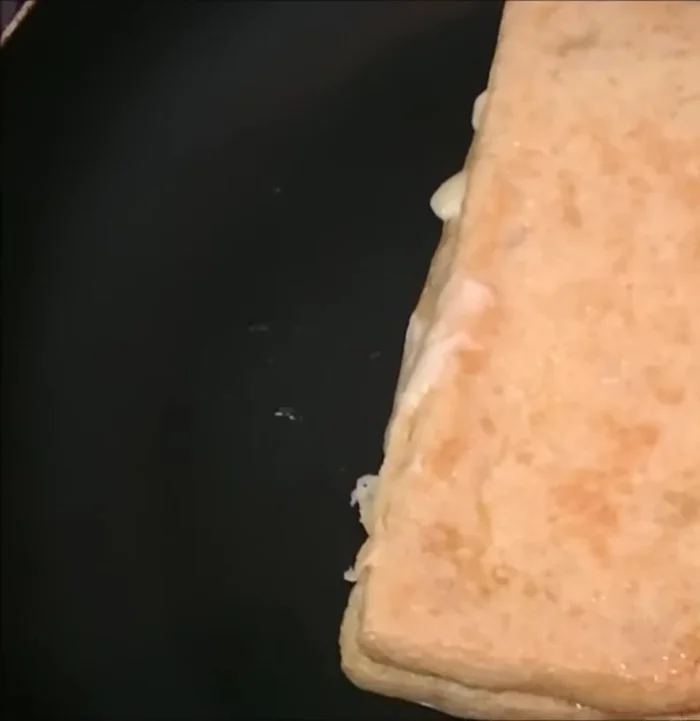 Flip the tofu pockets after about a minute. Continue cooking until the cheese is melted.