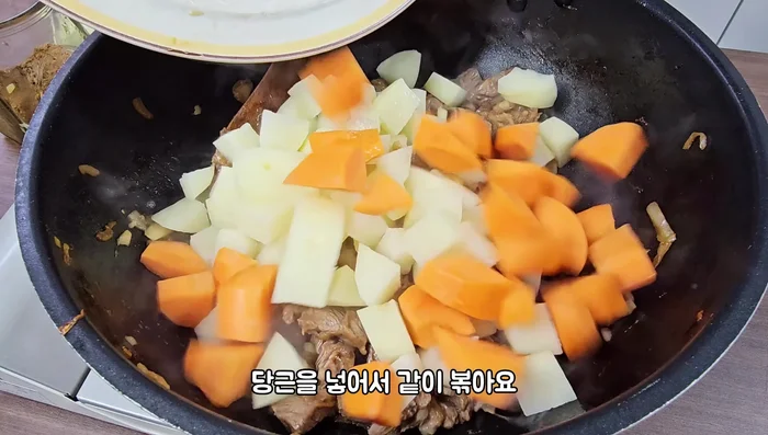 Add potatoes and carrots and stir-fry until slightly cooked for a savory taste and to maintain shape.