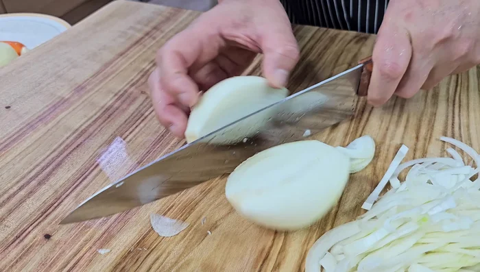 Generously slice the onions thinly. Peel and prepare two onions.