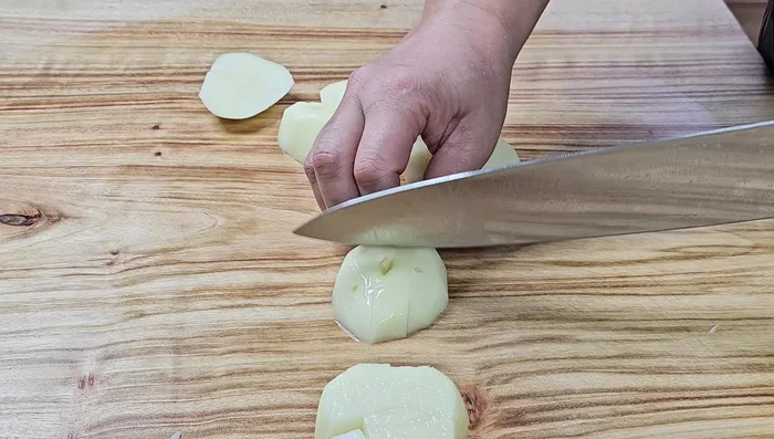 Cut potatoes into bite-sized cubes. Rinse them in water to prevent sticking while stir-frying.