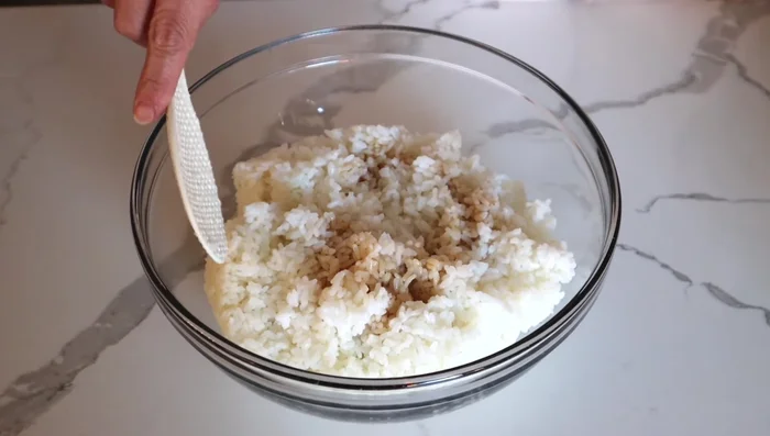 Season the steamed rice with menuy sauce.