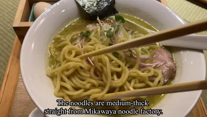 Cook the Noodles: Use medium-thick noodles (the video mentions Awa Noodle Factory). Cook according to package directions until al dente.