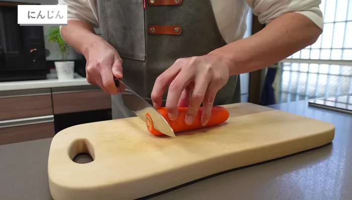 Cut the carrots, leaving the skin on. Stack several thin slices and cut into thin strips.