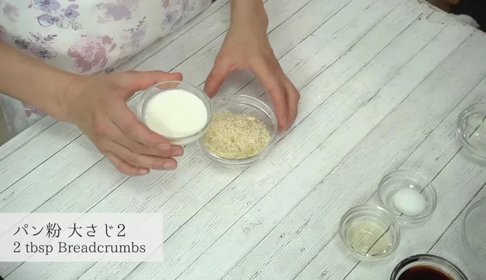 Soften breadcrumbs by adding milk and mixing well.