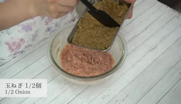 Add half of the cooled fried onions to the meat mixture and mix well.