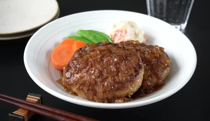Pour the sauce over the hamburger steaks and serve immediately.