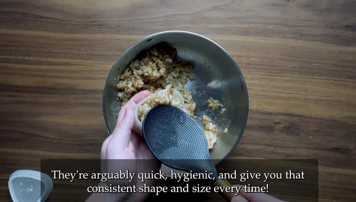 Mold shaping: Press rice gently into onigiri molds, ensuring it's filled to the top. Press firmly with the lid, then remove the mold.