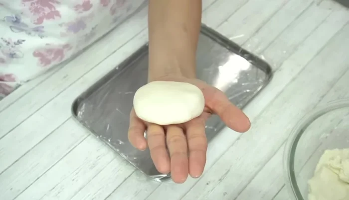 Roll the wrapped mochi into an oblong shape.