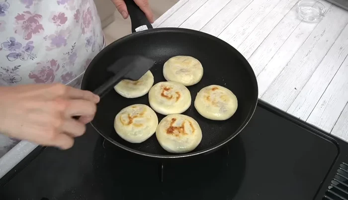 Flip the mochi, press gently, add 1 tbsp of water, cover, and steam-bake for another 5 minutes.