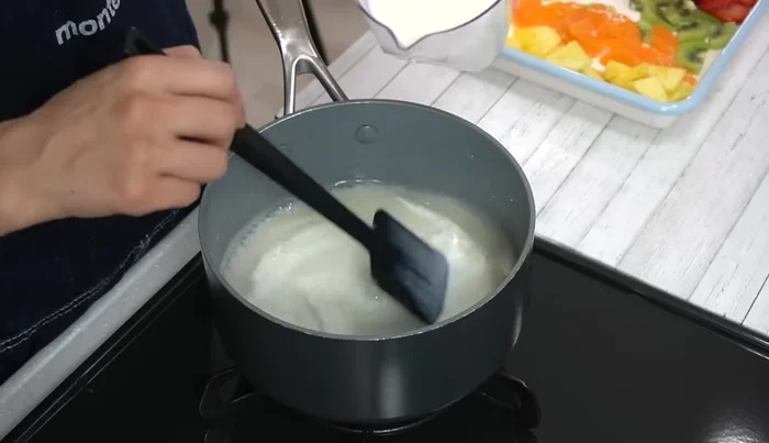 Add half of the milk to the jelly, stir well, then add the remaining milk and stir until the mixture slightly bubbles. Avoid boiling.