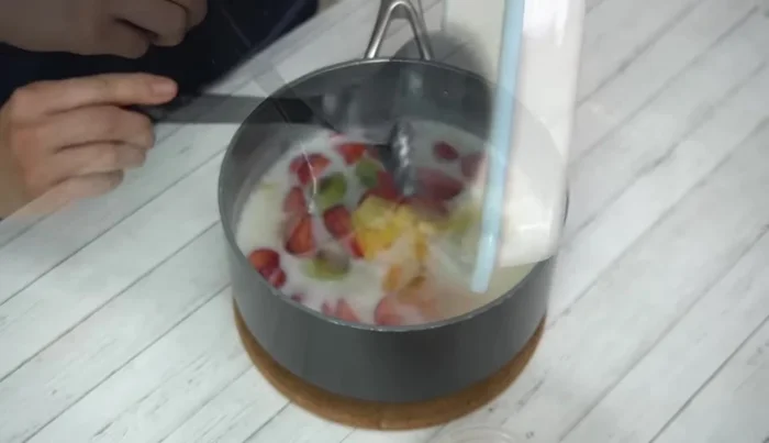 Add remaining fruit. Stir gently. Pour any leftover milk into a separate container.