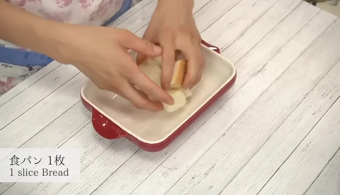 Layer bread slices in a baking dish, top with the white sauce, and then add melted cheese.