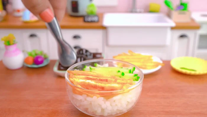 Assemble the Unagi Don: place cooked rice in a bowl, top with grilled eel, shrimp, cucumber, and eggs.
