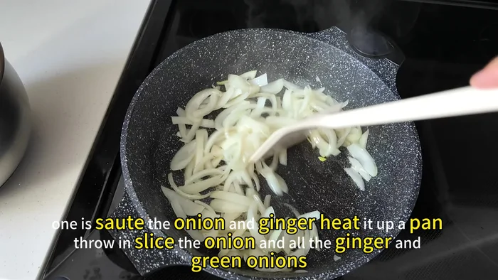 Sauté the onion and ginger. Heat up a pan, add sliced onion, ginger, and green onions. Cook until soft.